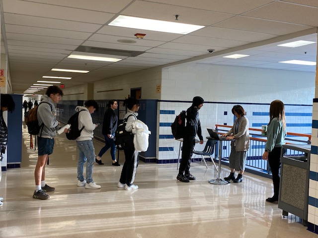 Students line up at a tardy station before 1st period.