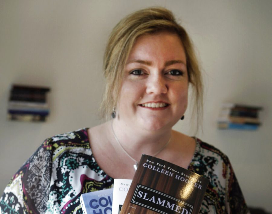 In the photo made Tuesday, Feb. 5, 2013, self publishing author Colleen Hoover posses and holds copies her books in Sulphur Springs, Texas. Hoovers romance novels books have made the New York Times bestseller list. (AP Photo/LM Otero)
