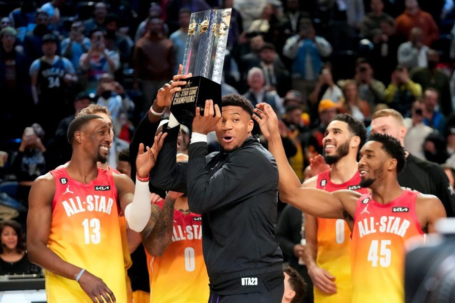 Giannis Antetokounmpo hoists the All Star Game trophy.
