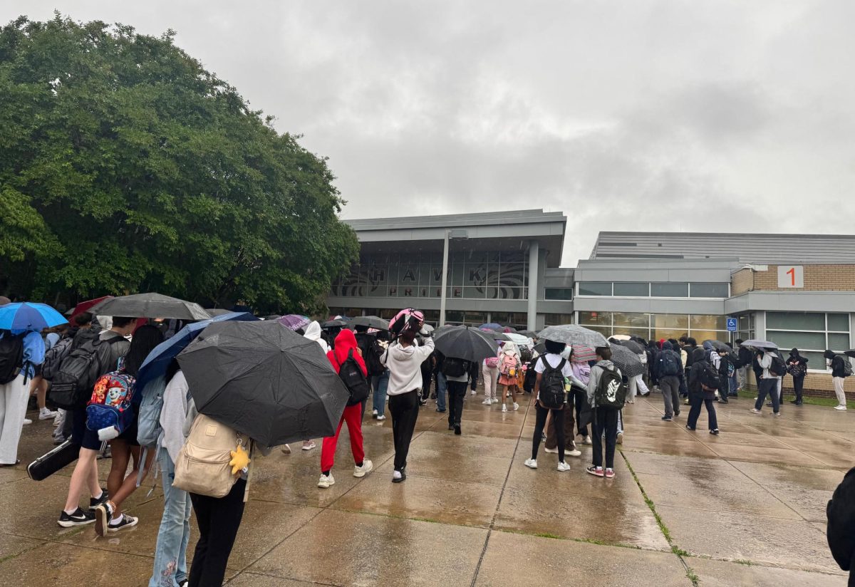 Students are waiting outside of the building in pouring rain until the building opens at 7:40 a.m.