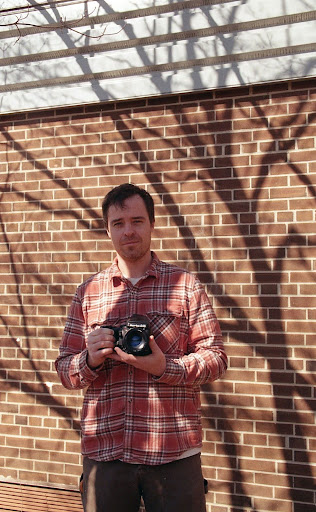 Casey Shannon standing in the Hayfield Courtyard. 
