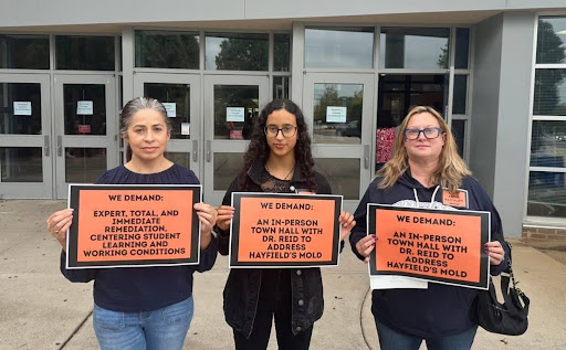 Community members holding signs at Hayfield Secondary School on Back to School Night. Photo courtesy of Judy Conti